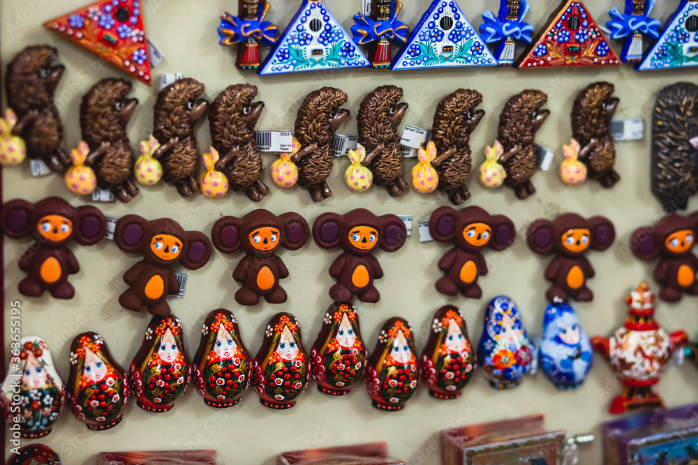 Wall mural View of traditional souvenirs from Saint-Petersburg, Russia, with fridge magnets of russian dolls, matryoshka, balalaika, ballet dancer, vodka bottle at local vendor souvenir shop on Nevsky Prospect