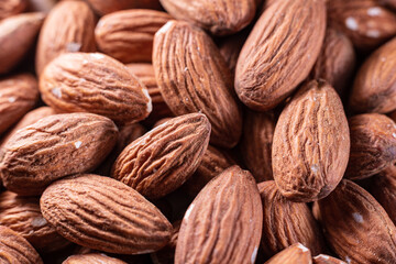 Closeup of shiny peeled almond seeds. Peeled almond texture. Superfood. Natural food.