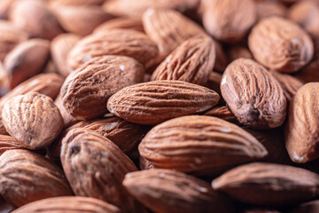 Closeup of shiny peeled almond seeds. Peeled almond texture. Superfood. Natural food.