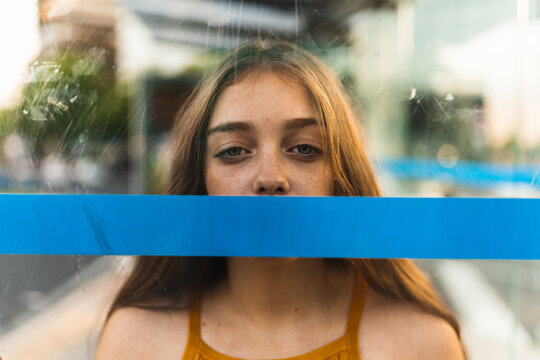 pretty girl glass and a blue line covering her mouth