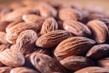 Closeup of shiny peeled almond seeds. Peeled almond texture. Superfood. Natural food.