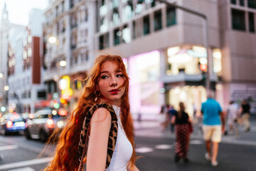 attractive girl walking downtown looking back toward camera