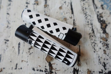 Two black and white modern lighters on old vintage table