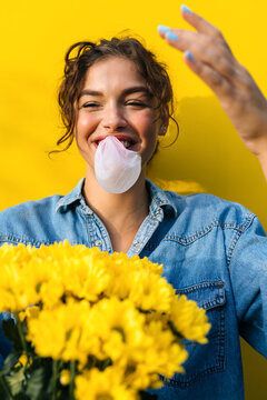 Woman With Flowers Doing Ballon With Gum