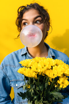 Woman With Flowers Doing Ballon With Gum