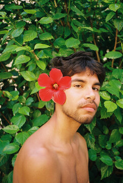 Red Tropical Flower In His Hair.