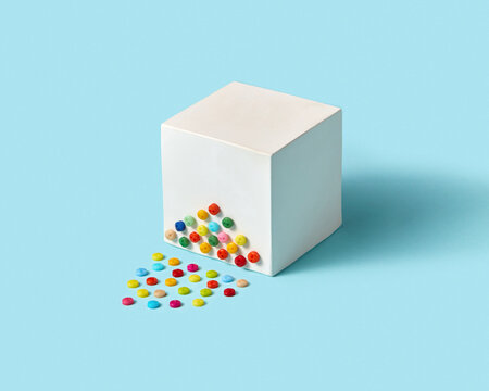 White paper cube with colored buttons.