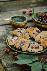 Cranberry & Cherry Scones. Baking on an old wooden table in rustic style.