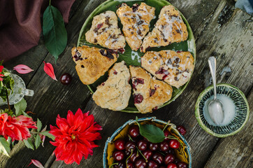 Cranberry & Cherry Scones. Baking on an old wooden table in rustic style.