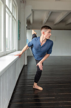 Young man training ballet at school.