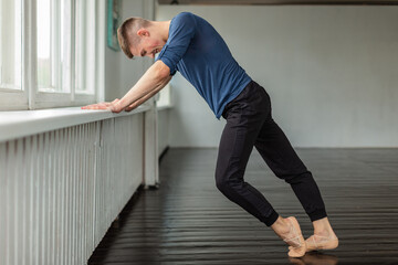 Young man training ballet at school.