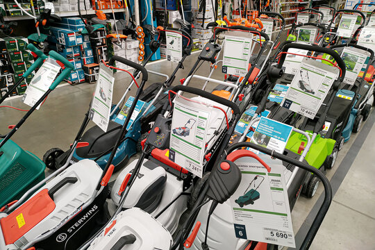 Moscow, Russia - August 17, 2019: Contemporary petrol and electric lawn mowers in a building materials hypermarket