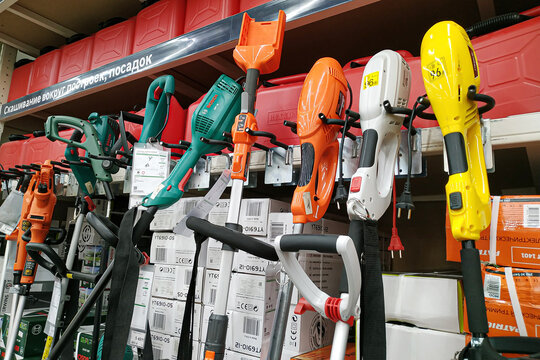 Moscow, Russia - August 17, 2019: Various garden trimmers on the stand in a building materials hypermarket close-up