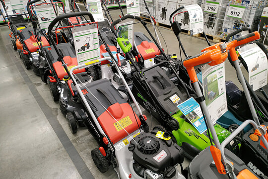 Moscow, Russia - August 17, 2019: Contemporary petrol and electric lawn mowers in a building materials hypermarket