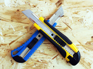 Two cutters on a wooden background, knives