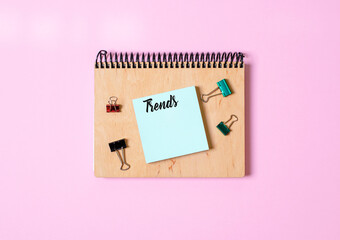 Notebook for entries with wooden cover, paper clips, notes for notes with the words Trends