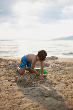 8 year old boy playing on the beach