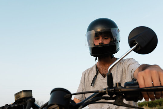 Serious man in helmet riding motorcycle