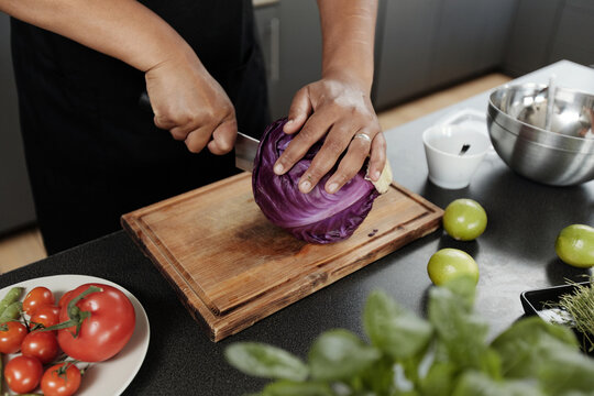 Unrecognizable Woman Cutting Cabbage