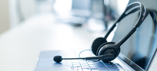 Call center operator desktop. Close-up of a headset on a laptop. Help desk. Workplace of a support...