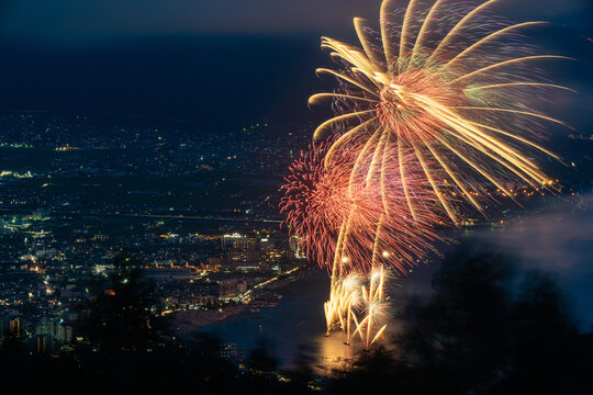Fireworks at Local City in Japanese Countryside Beside the Lake Surrounded Mountains