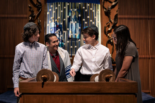 Synagogue: Rabbi Laughs With Teens While Practicing Reading