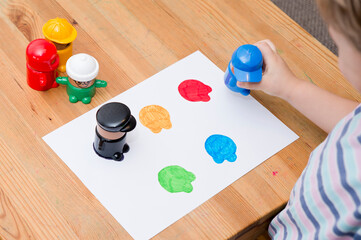 The child learns to know colors. Little toddler boy playing colors figurines cups learning materials in a montessori methodology school being manipulated by children.