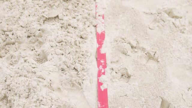 Line markings on the sand for beach volleyball on the street.