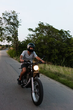Man riding motorcycle along countryside road