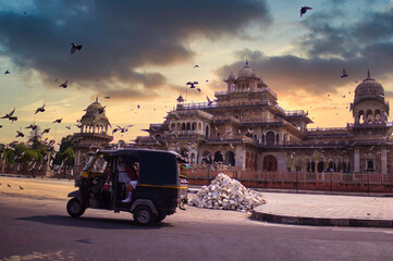 An Indian tuk tuk ( Auto Rikshaw ) taking school students in front of palace lookalike Albert hall...