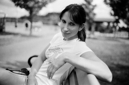 Black and white portrait of a beautiful woman sitting on a bench