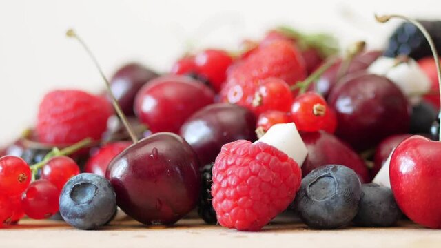group of mixed fresh berries and cubes of coconut