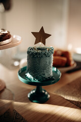 a delicious and pretty birthday cake with a star-shaped decoration on it