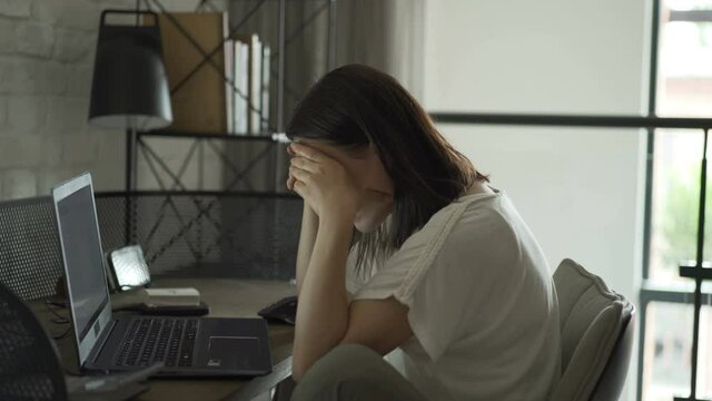 Tired sleepy woman yawning, working at office desk , overwork and sleep deprivation concept