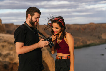 photographer and female model checking photos.
