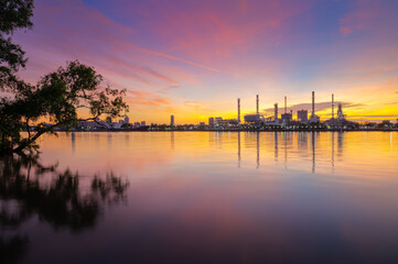 oil refinery plant chemical factory and power plant with many storage tanks and pipelines at sunrise