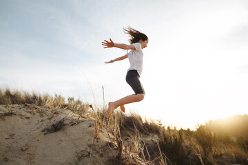 Adventurous kids exploring sand dunes in Florence Oregon at sunset