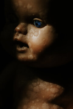 close up of a vintage baby doll, in the shadow