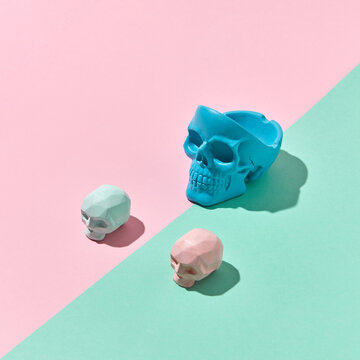 Three colorful skulls with shadows.