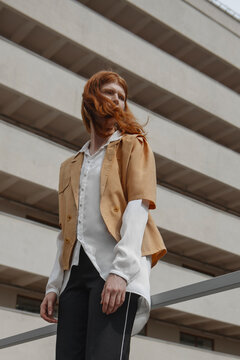 low angle of a stylish red-haired girl