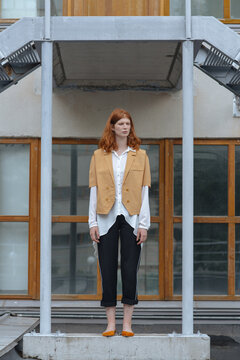 Symmetrical composition with a beautiful red-haired girl