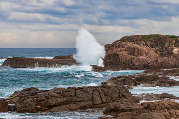 Rocky Seascape with Blue Aquamarine Sea and Earthy Brown Rocks