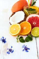 Juicy sliced ​​citrus fruits with a summer drink. Quenching thirst