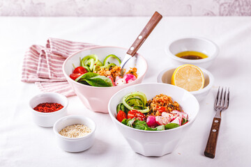 Fresh salad with couscous, tomatoes, cucumber, radish and chard.