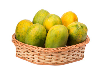papayas in wicker basket on isolated white background