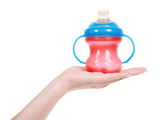 Hand with red child feed and drink bottle. Isolated on white background.