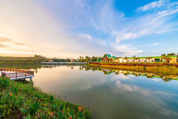 Obraz premium Outdoor park square with brick walkways and wooden paths at sunrise and sunset.