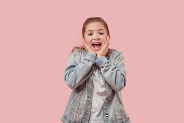 Cute beautiful girl with open mouth and a smile looks at the camera.