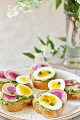 watermelon radish sandwich with avocado and egg. healthy balanced breakfast. bright toast