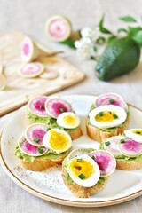 watermelon radish sandwich with avocado and egg. healthy balanced breakfast. bright toast
